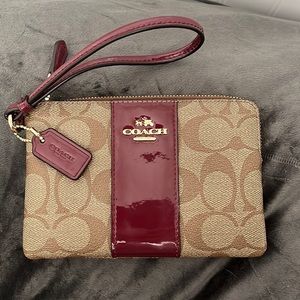 Small brown and burgundy leather Coach wristlet